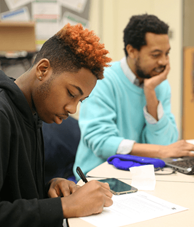 High school student works with a uAspire advisor to complete college financial forms